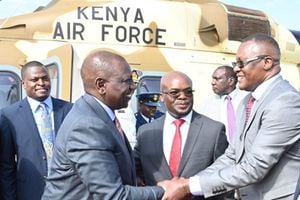 President William Ruto (left) is welcomed to Homa Bay by ICT Cabinet Secretary Eliud Owalo
